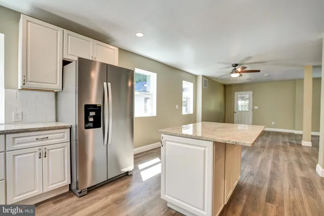 a kitchen with stainless steel appliances a refrigerator sink and cabinets