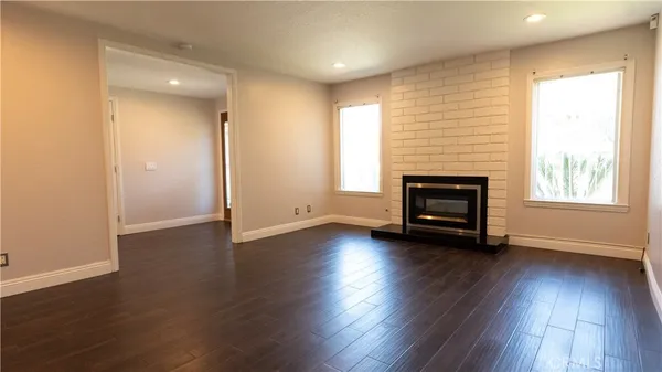a view of kitchen with refrigerator and window