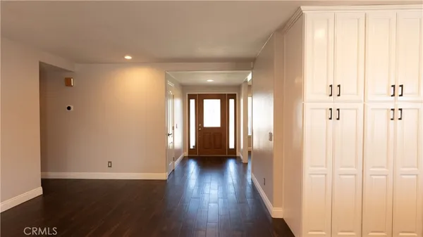 a view of a kitchen with wooden floor and a window
