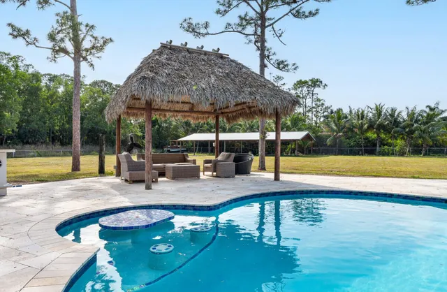 swimming pool view with a seating space