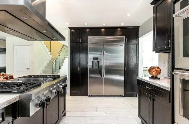 a kitchen with a stove and a refrigerator