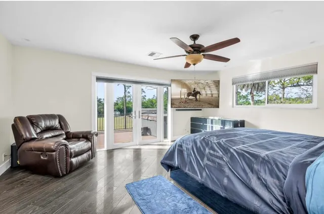a bedroom with a large bed and a large window