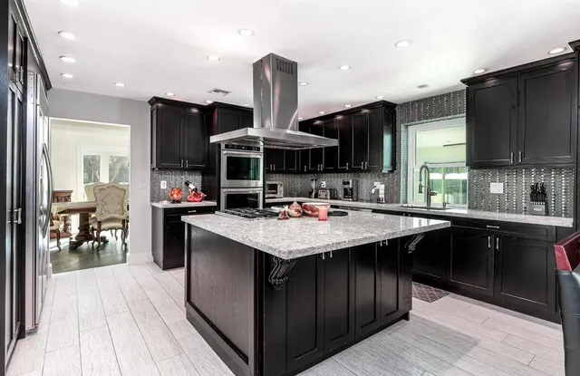 a kitchen with a sink cabinets and wooden floor