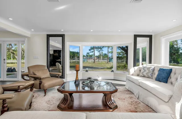 a living room with furniture and a large window