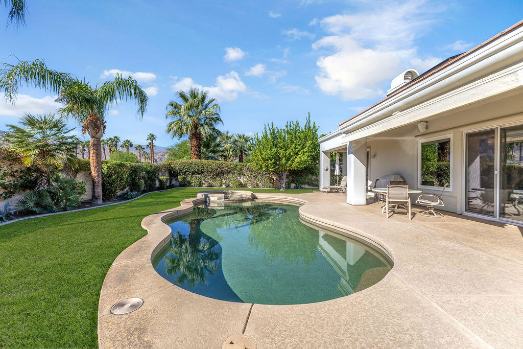 29 Calle La Reina Rancho Mirage, CA 92270 - Photo 2 of 49 a view of a swimming pool with an outdoor seating