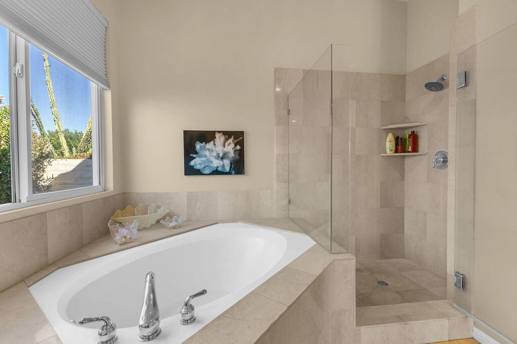 29 Calle La Reina Rancho Mirage, CA 92270 - Photo 22 of 49 a bathroom with a tub a sink and shower