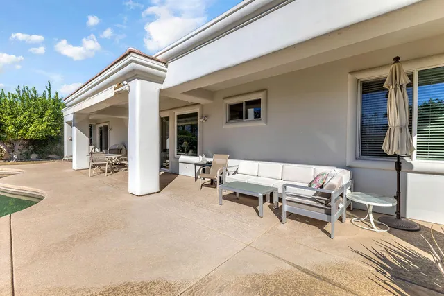 a view of a house with a swimming pool and a yard