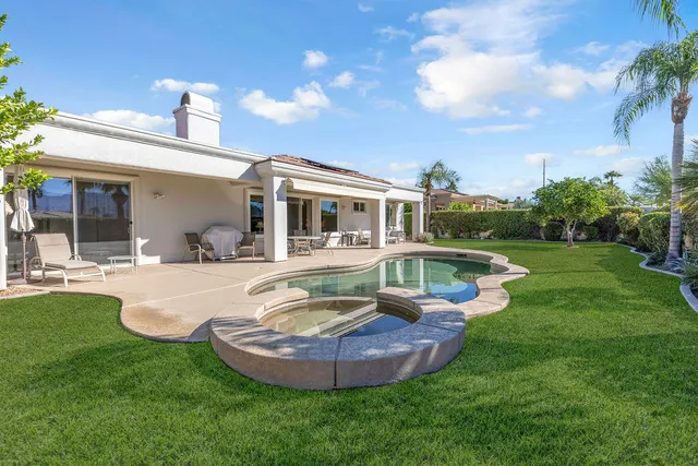 a view of swimming pool with a yard