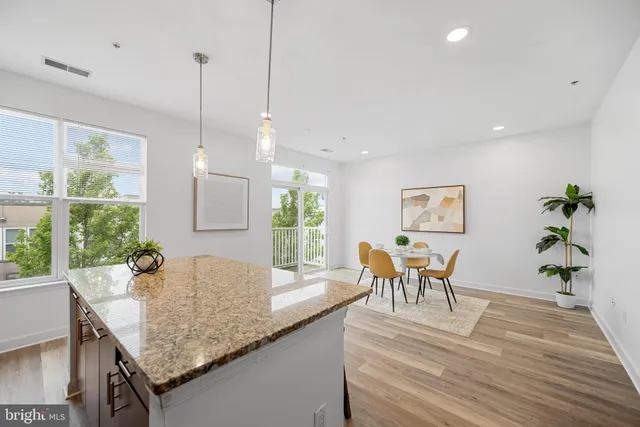 a view of a kitchen area with furniture and wooden floor