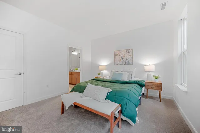 a bedroom with a bed and a chair