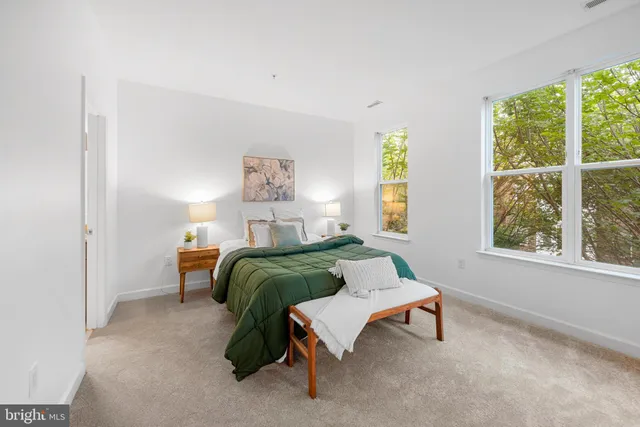 a bedroom with a bed and a table