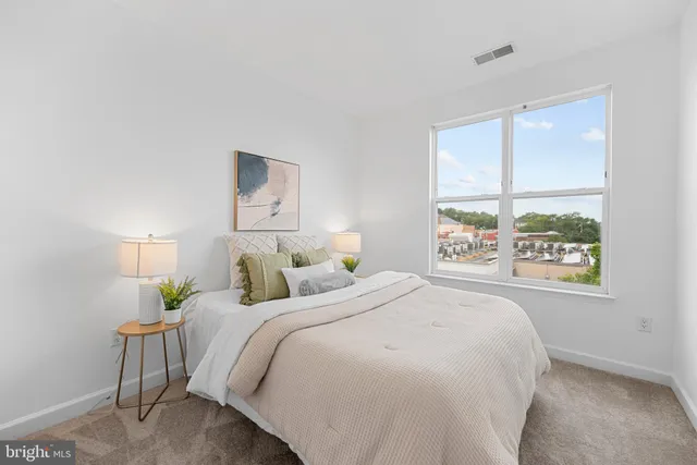 a bedroom with a large bed and a window