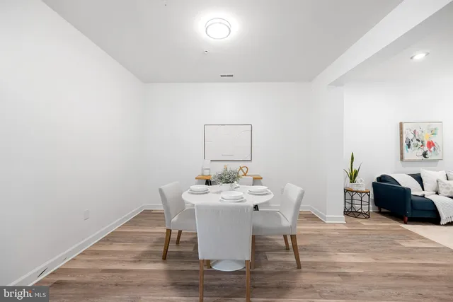 a dining room with furniture and wooden floor