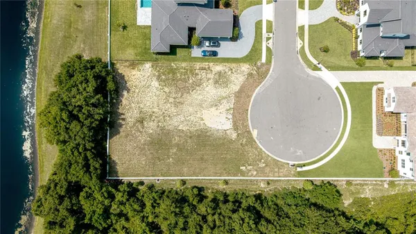 an aerial view of a house with a lake view