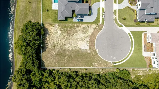 an aerial view of a house with a lake view