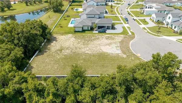 an aerial view of residential house with outdoor space and swimming pool