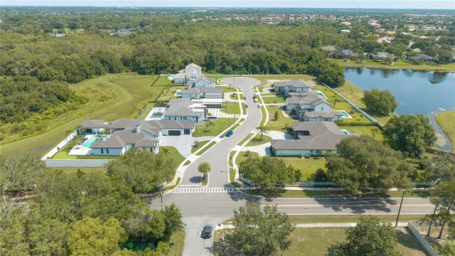 an aerial view of a house with swimming pool and ocean view