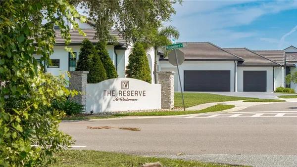 aerial view of a residential apartment building with a swimming pool and outdoor seating