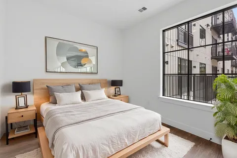 a bedroom with a bed and a window
