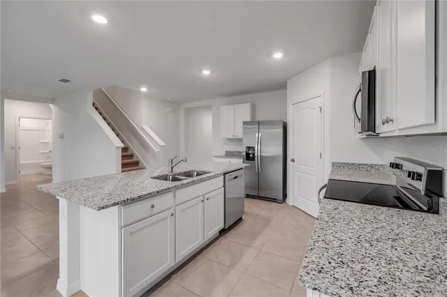 a kitchen with a sink stove and refrigerator
