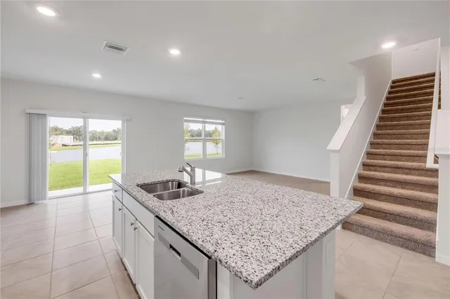 a view of kitchen and hall with wooden floor