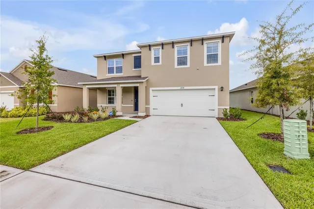 a front view of house with yard and green space