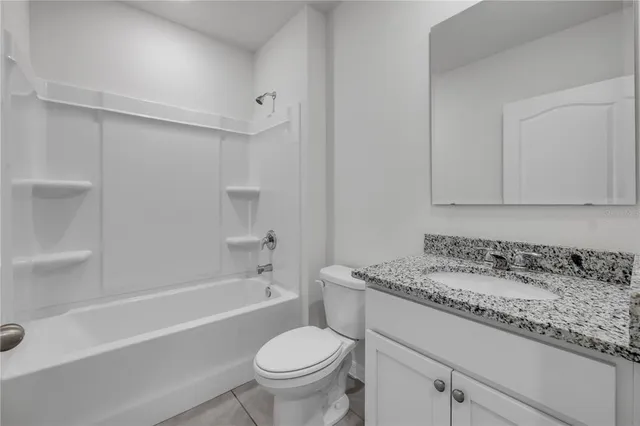 a bathroom with a sink toilet vanity and bathtub