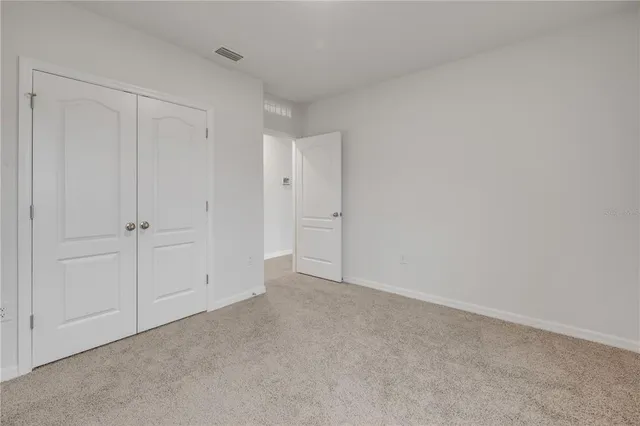 a view of an empty room and entryway