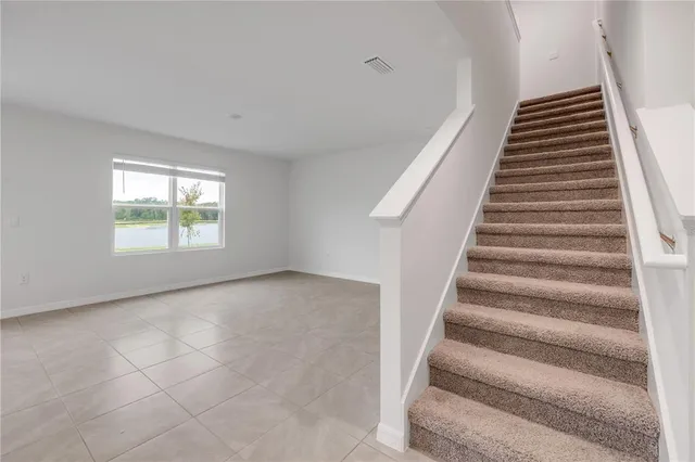 a view of an empty room with stairs