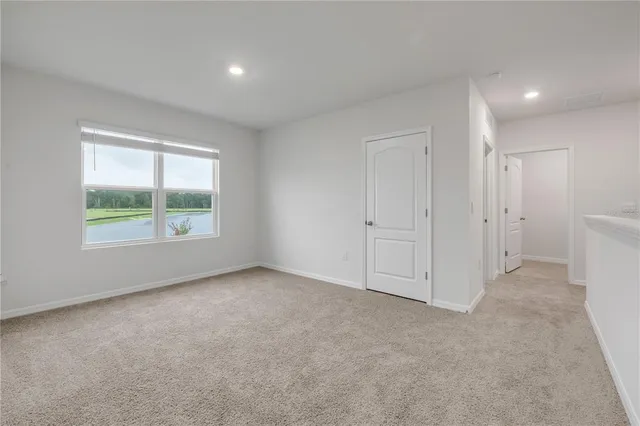 an empty room with windows and closet