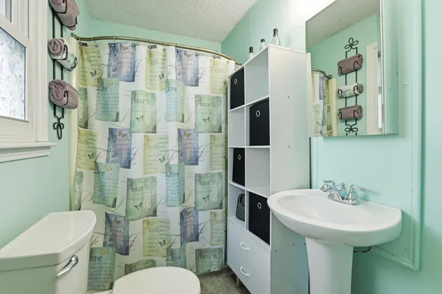 a bedroom with a bed and a dresser in it