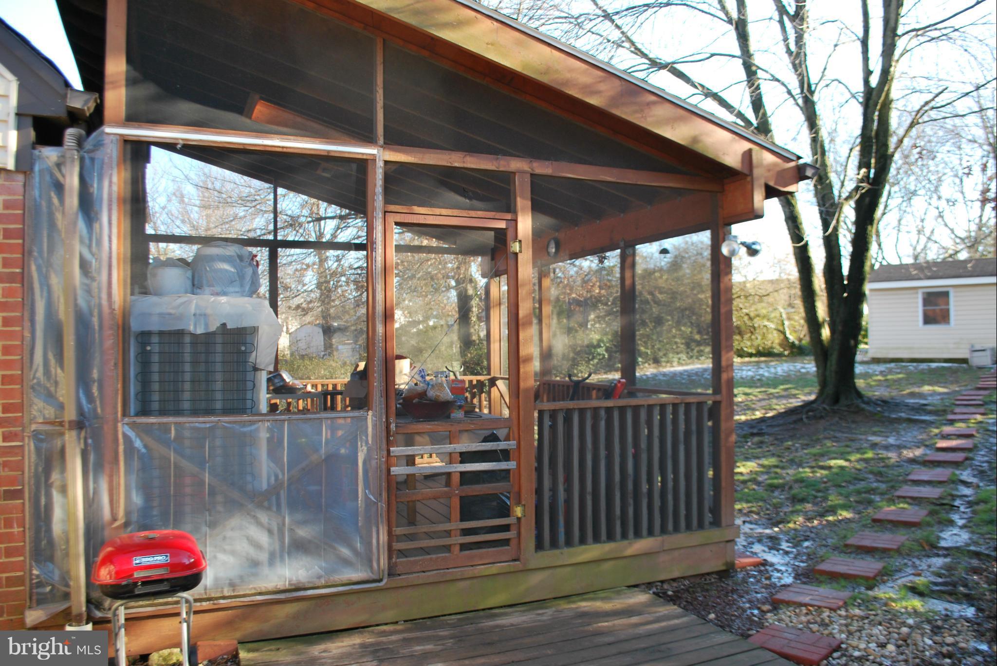 6833 Inverness Drive Springfield, VA 22150 - Photo 22 of 30 a view of a porch with a table and chairs