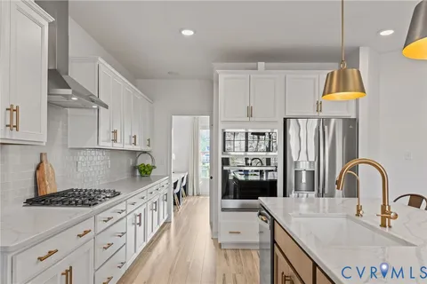 a kitchen with kitchen island granite countertop a sink stainless steel appliances and cabinets