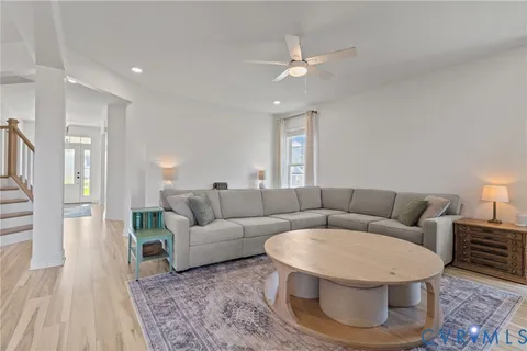 a living room with furniture and kitchen view