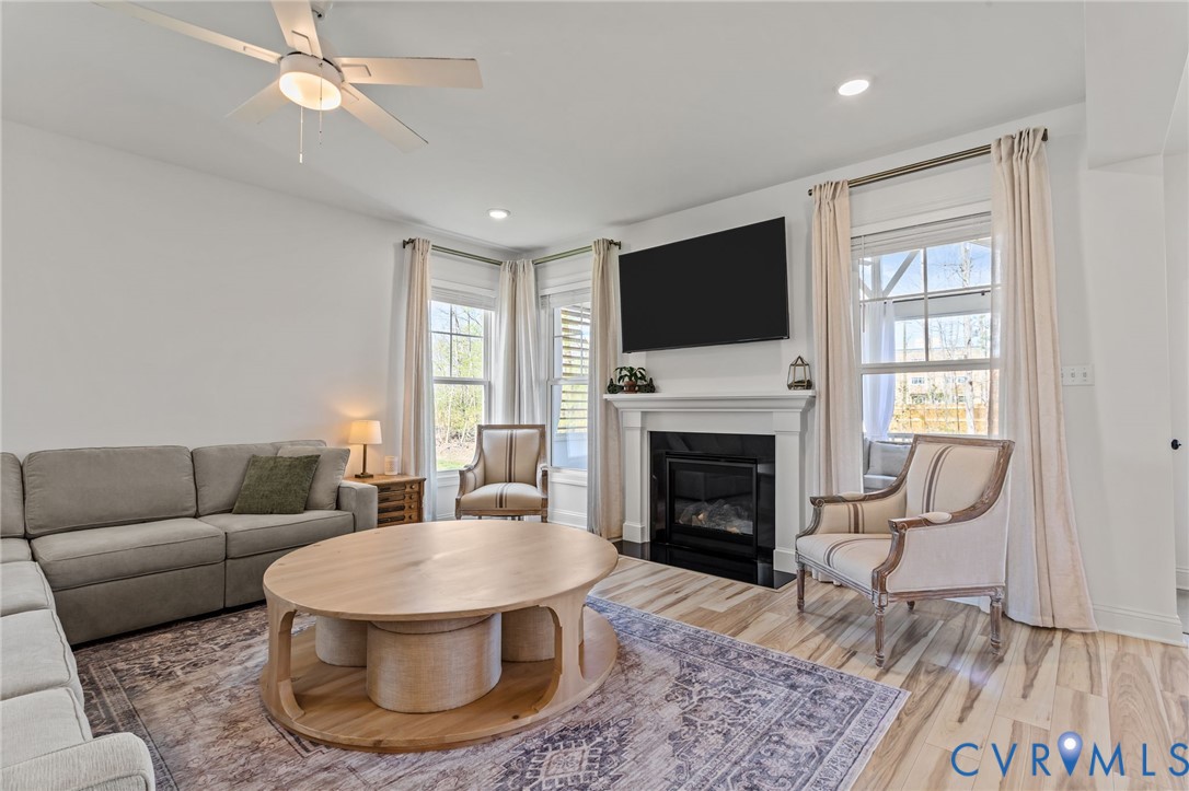 4700 Melbrook Way Moseley, VA 23120 - Photo 19 of 58 a living room with furniture a flat screen tv and a fireplace