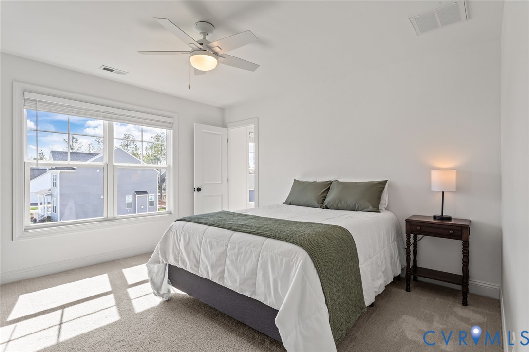 4700 Melbrook Way Moseley, VA 23120 - Photo 25 of 58 a spacious bedroom with a bed and a window