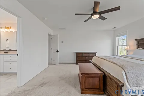a bathroom with a tub and a view of living room
