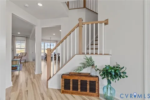 a view of staircase with wooden floor and a potted plant