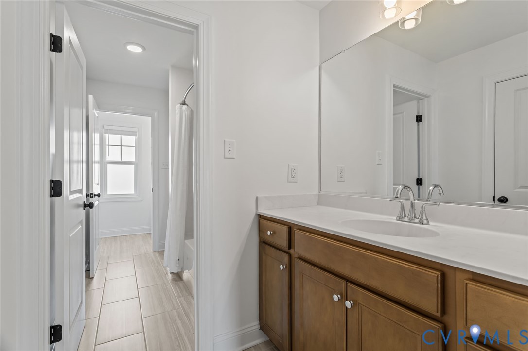4700 Melbrook Way Moseley, VA 23120 - Photo 34 of 58 a bathroom with a sink and a mirror