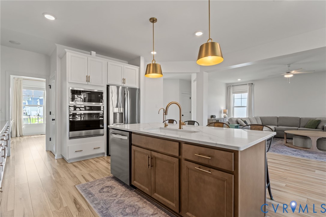 4700 Melbrook Way Moseley, VA 23120 - Photo 10 of 58 a kitchen with stainless steel appliances granite countertop a sink a stove and a wooden floors