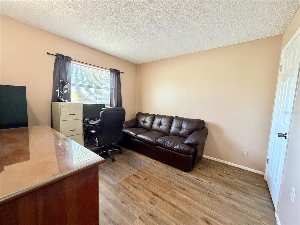 9840 Crofton Lane Port Richey, FL 34668 - Photo 10 of 12 a living room with furniture and a flat screen tv