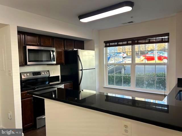 104 Kendrick Place, Unit 18 Gaithersburg, MD 20878 - Photo 2 of 18 a kitchen with a large window and a refrigerator