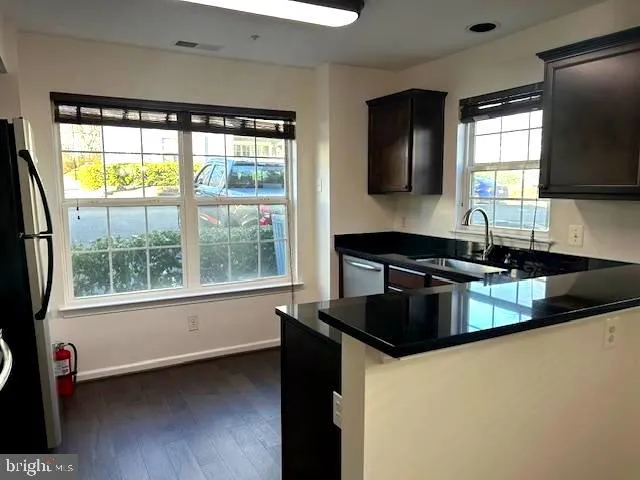 a kitchen with a large window and a sink