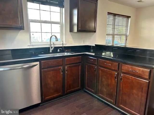 a kitchen with granite countertop cabinets sink and window