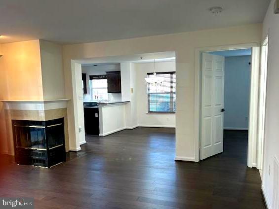 104 Kendrick Place, Unit 18 Gaithersburg, MD 20878 - Photo 6 of 18 an empty room with wooden floor fireplace and windows
