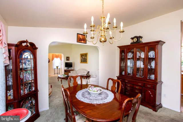 a view of a dining room with furniture and chandelier