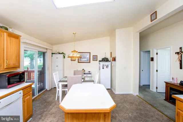 a living room with furniture and a kitchen island