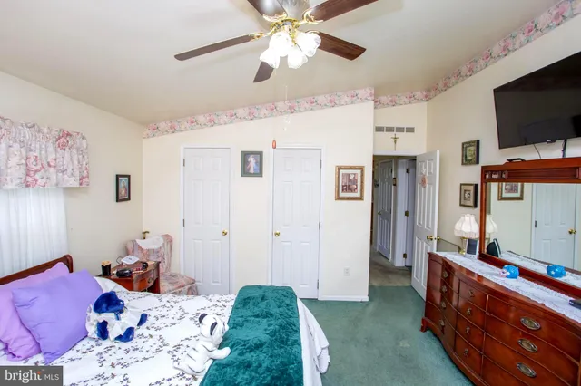 a bedroom with furniture and a flat screen tv