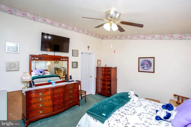 a bedroom with a bed and flat screen tv
