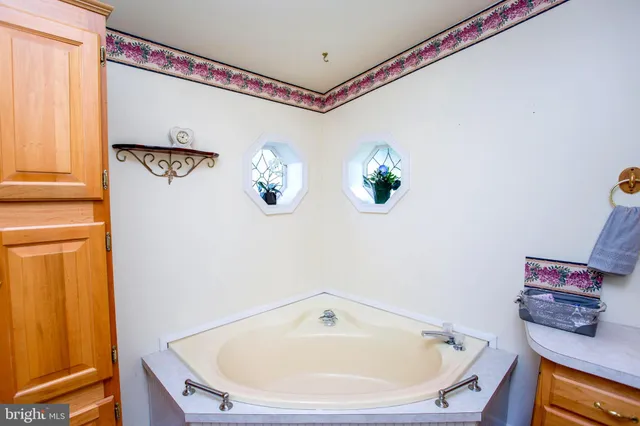 a bathroom with a bathtub and a window
